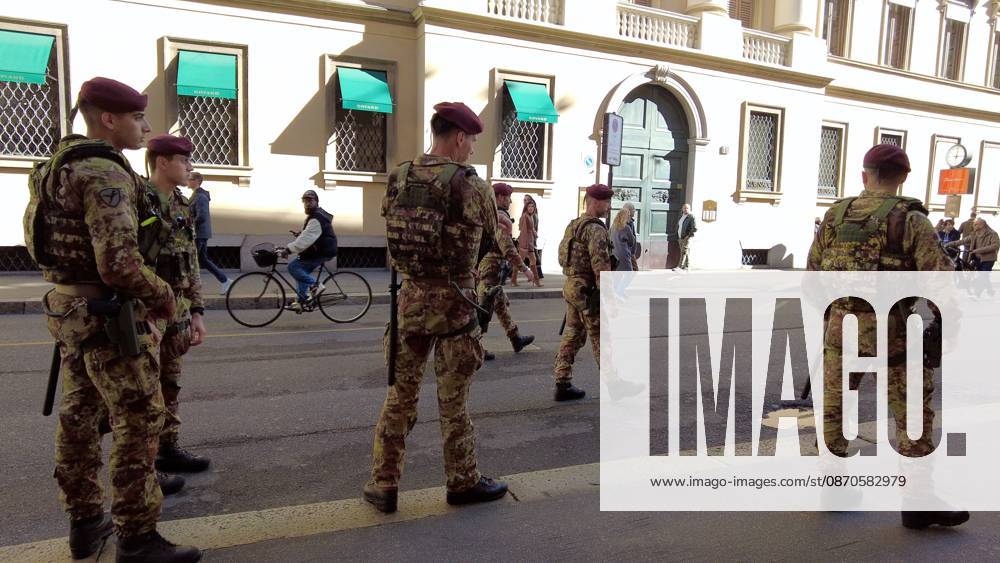 IPA90116624 - Italy, Milan: Luxury stores on Via Montenapoleone with shop windows barricaded against looting, and soldiers from the Folgore Brigade patrolling the streets to keep out looters and violent protesters