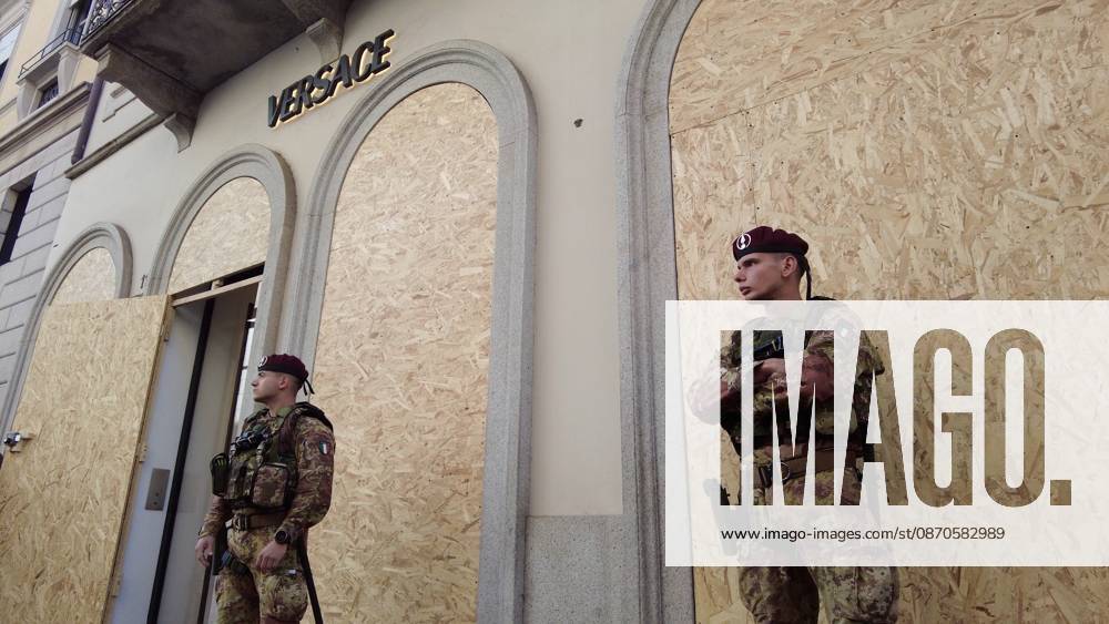 IPA90116647 - Italy, Milan: Luxury stores on Via Montenapoleone with shop windows barricaded against looting, and soldiers from the Folgore Brigade patrolling the streets to keep out looters and violent protesters