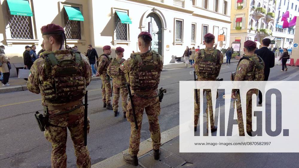 IPA90116621 - Italy, Milan: Luxury stores on Via Montenapoleone with shop windows barricaded against looting, and soldiers from the Folgore Brigade patrolling the streets to keep out looters and violent protesters