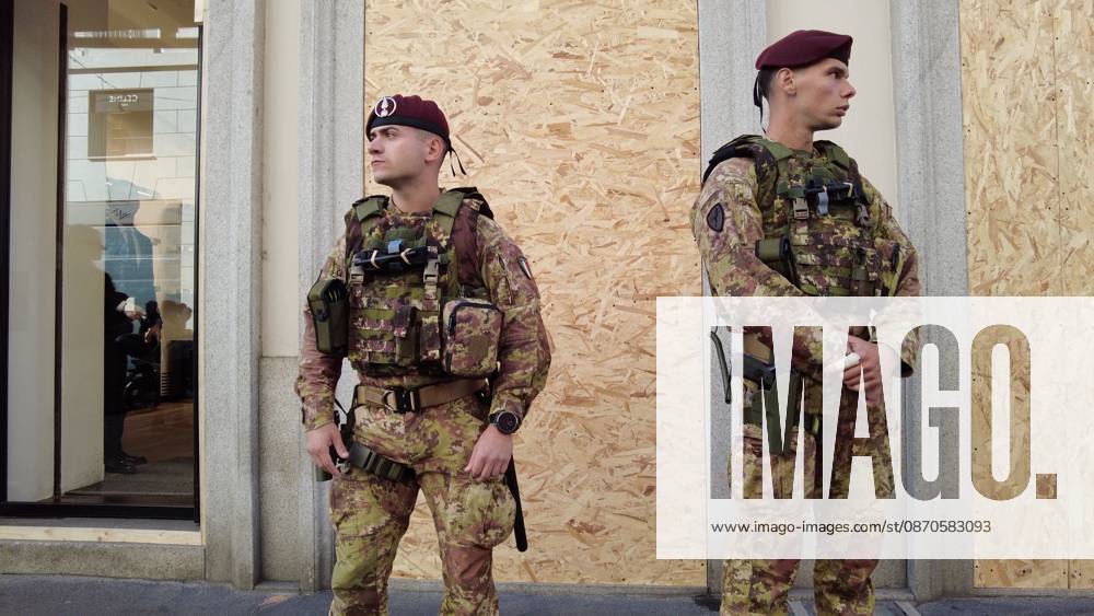 IPA90116643 - Italy, Milan: Luxury stores on Via Montenapoleone with shop windows barricaded against looting, and soldiers from the Folgore Brigade patrolling the streets to keep out looters and violent protesters