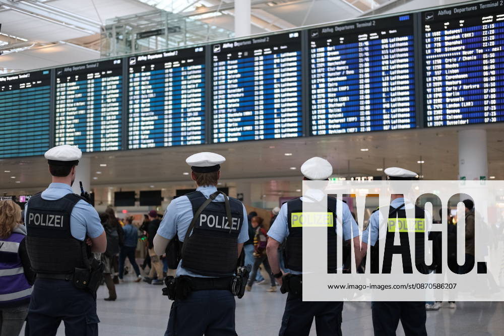 Protest at Munich Airport against planned deportation terminal MUNICH, GERMANY - OCTOBER 24: German federal police officers stand inside Munich Airport looking towards the departures board in Munich, Germany on October 24, 2026. Officers were deployed at the airport as protesters rallied against a planned deportation terminal at the site. Merve Goettl Anadolu Munich Germany. Editorial use only. Please get in touch for any other usage.