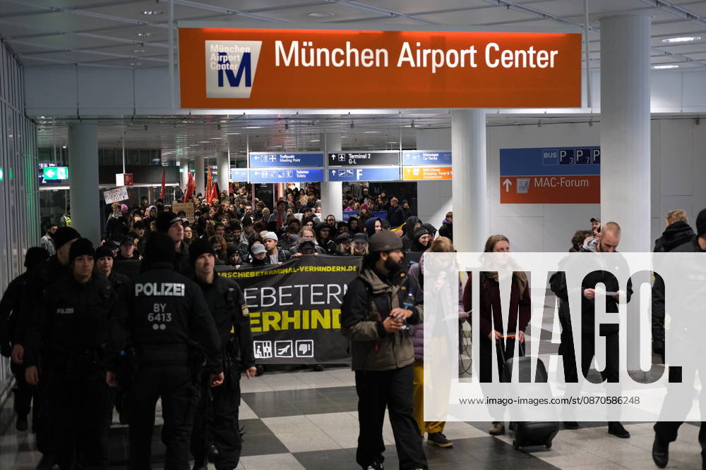 Protest at Munich Airport against planned deportation terminal MUNICH, GERMANY - OCTOBER 24: Police officers escort a crowd of demonstrators carrying a banner reading Abschiebeterminal verhindern (Stop the Deportation Terminal) through the Munchen Airport Center in Munich, Germany on October 24, 2026. The protest targets a planned deportation terminal at Munich Airport that the federal government intends to use for mass deportations from 2028. Merve Goettl Anadolu Munich Germany. Editorial use only. Please get in touch for any other usage.