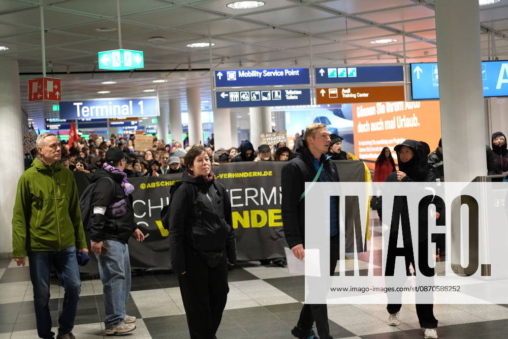Protest at Munich Airport against planned deportation terminal MUNICH, GERMANY - OCTOBER 24: Protesters march through Terminal 1 at Munich Airport carrying a banner reading Abschiebeterminal MUC verhindern (Stop the MUC Deportation Terminal) during a demonstration against a planned deportation terminal in Munich, Germany on October 24, 2026. The campaign, backed by the Bavarian Refugee Council and other organizations, opposes the federal government s plans to process mass deportations at the airport from 2028. Merve Goettl Anadolu Munich Germany. Editorial use only. Please get in touch for any other usage.