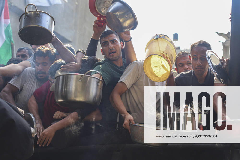 Gaza Palestinians Food Shortages 2026 Palestinians press toward a charity kitchen carrying pots and bowls to receive hot food in Jabalia Refugee Camp, northern Gaza Strip, Palestine, on October 24, 2026. Community kitchens remain a key source of food in Gaza, where UN humanitarian agencies reported cuts to cooked-meal distributions in October because of funding shortages. Jabalia Gaza Strip Palestinian Territories
