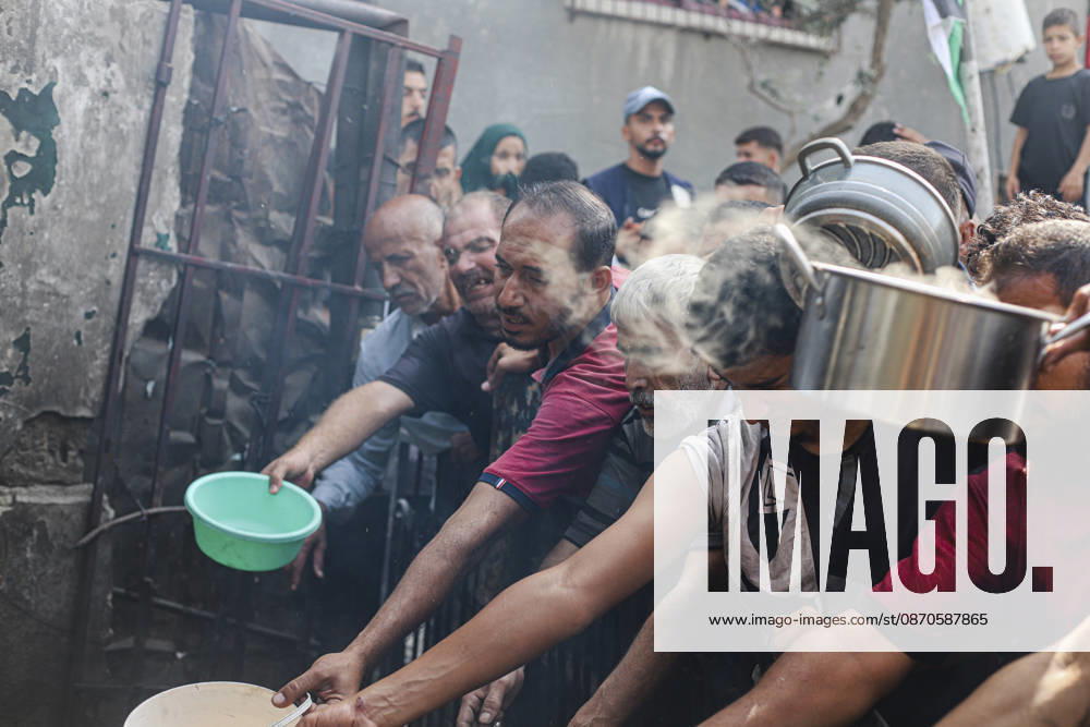 Gaza Palestinians Food Shortages 2026 Palestinians press toward a charity kitchen carrying pots and bowls to receive hot food in Jabalia Refugee Camp, northern Gaza Strip, Palestine, on October 24, 2026. Community kitchens remain a key source of food in Gaza, where UN humanitarian agencies reported cuts to cooked-meal distributions in October because of funding shortages. Jabalia Gaza Strip Palestinian Territories