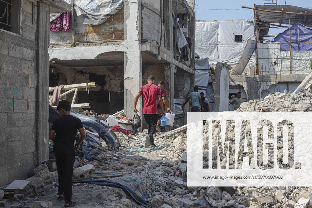 Gaza Palestinians Food Shortages 2026 Palestinian residents walk through a rubble-strewn street past heavily damaged buildings in Jabalia Refugee Camp, northern Gaza Strip, Palestine, on October 24, 2026. The UN reports that damaged infrastructure, displacement and shortages of basic supplies continue to affect residents of Gaza, while funding shortages have reduced food assistance. Jabalia Gaza Strip Palestinian Territories