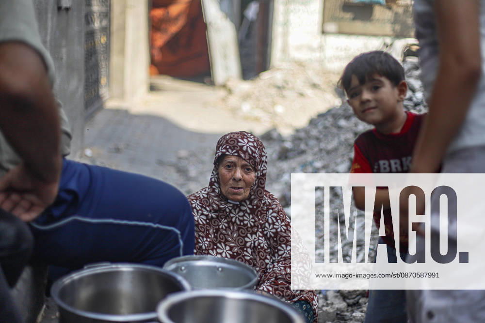Gaza Palestinians Food Shortages 2026 Palestinians wait with metal cooking pots at a charity kitchen in Jabalia Refugee Camp, northern Gaza Strip, Palestine, on October 24, 2026. Community kitchens remain a key source of food in Gaza, where UN humanitarian agencies reported cuts to cooked-meal distributions in October because of funding shortages. Jabalia Gaza Strip Palestinian Territories