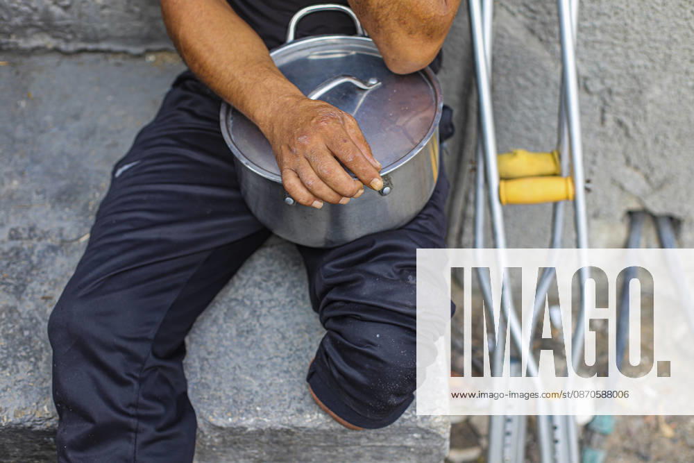 Gaza Palestinians Food Shortages 2026 A Palestinian man rests a metal cooking pot on his lap beside a pair of crutches in Jabalia Refugee Camp, northern Gaza Strip, Palestine, on October 24, 2026. The UN says widespread damage, displacement and food shortages have left families across Gaza heavily dependent on humanitarian assistance, with food distributions reduced in October amid funding constraints. Jabalia Gaza Strip Palestinian Territories