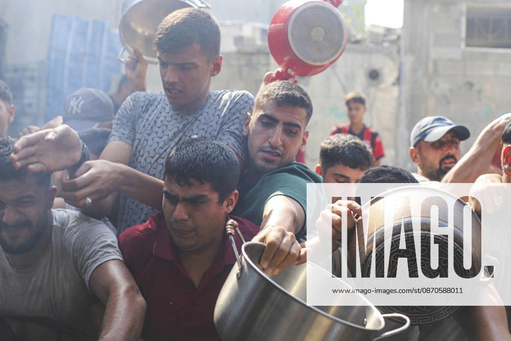 Gaza Palestinians Food Shortages 2026 Palestinians press toward a charity kitchen carrying pots and bowls to receive hot food in Jabalia Refugee Camp, northern Gaza Strip, Palestine, on October 24, 2026. Community kitchens remain a key source of food in Gaza, where UN humanitarian agencies reported cuts to cooked-meal distributions in October because of funding shortages. Jabalia Gaza Strip Palestinian Territories