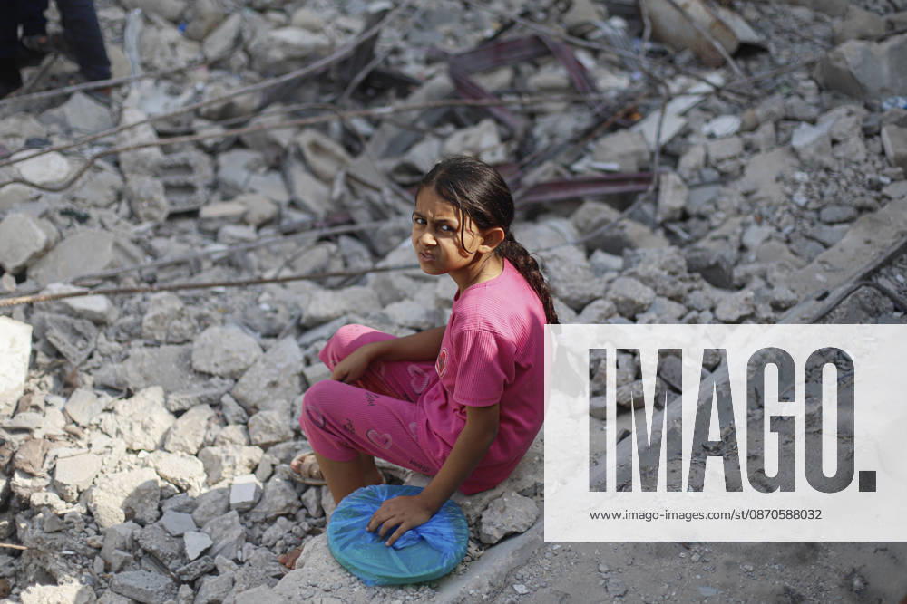 Gaza Palestinians Food Shortages 2026 A Palestinian girl in pink sits amid piles of rubble near a charity food distribution site in Jabalia Refugee Camp, northern Gaza Strip, Palestine, on October 24, 2026. The UN reports that damaged infrastructure, displacement and shortages of basic supplies continue to affect residents of Gaza, while funding shortages have reduced food assistance. Jabalia Gaza Strip Palestinian Territories