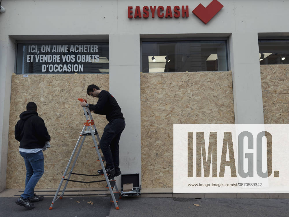 Lyon France Anti-Government Protest Men install wooden panels over the windows of a secondhand goods shop in Lyon, France, on October 24, 2026. Businesses in central Lyon took precautions amid concerns about further unrest following damage to shops during demonstrations the previous weekend. Lyon Rhone Alpes France