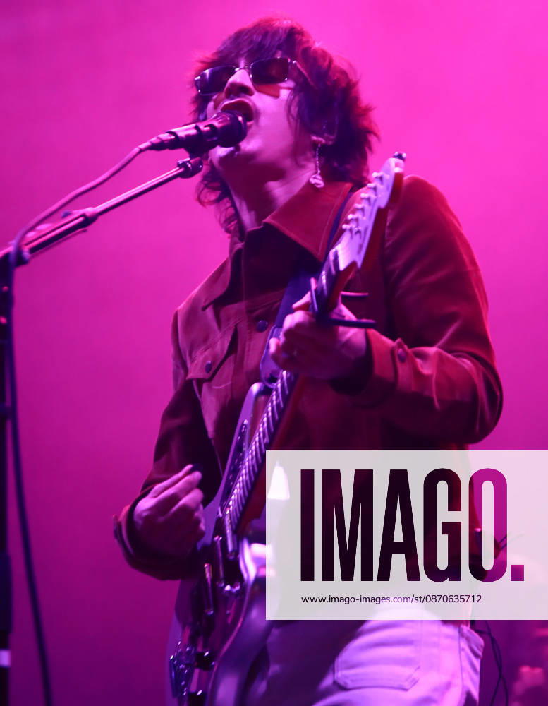 Mexican indie pop musician SIDDHARTHA plays an electric guitar and sings into a microphone under vibrant pink stage lighting during the Tecate Peninsula 2026 music festival at Explanada Estadio Caliente in Tijuana, Baja California, Mexico, October 24, 2026. He wears a brown jacket and dark sunglasses. Tijuana Mexico - ZUMAm311 20261024_zip_m311_010