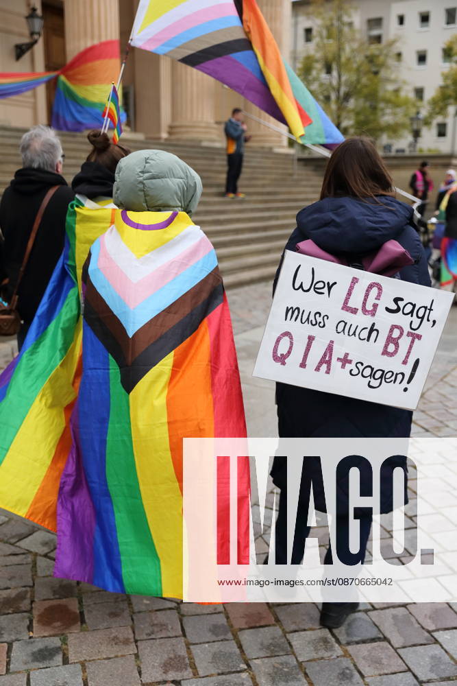 Protesters stand with a rainbow flag and a sign reading If you say LG, you must also say BTQIA at the Alter Markt during Bike Pride in Potsdam, October 24, 2026. Bike Pride Potsdam