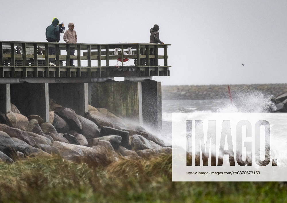 YSTAD, October 25, 2026: Storm watchers on the swimming pier at the small boat harbor in Ystad amid strong winds as Storm Boelo swept across southern Sweden on Sunday. YSTAD, SWEDEN