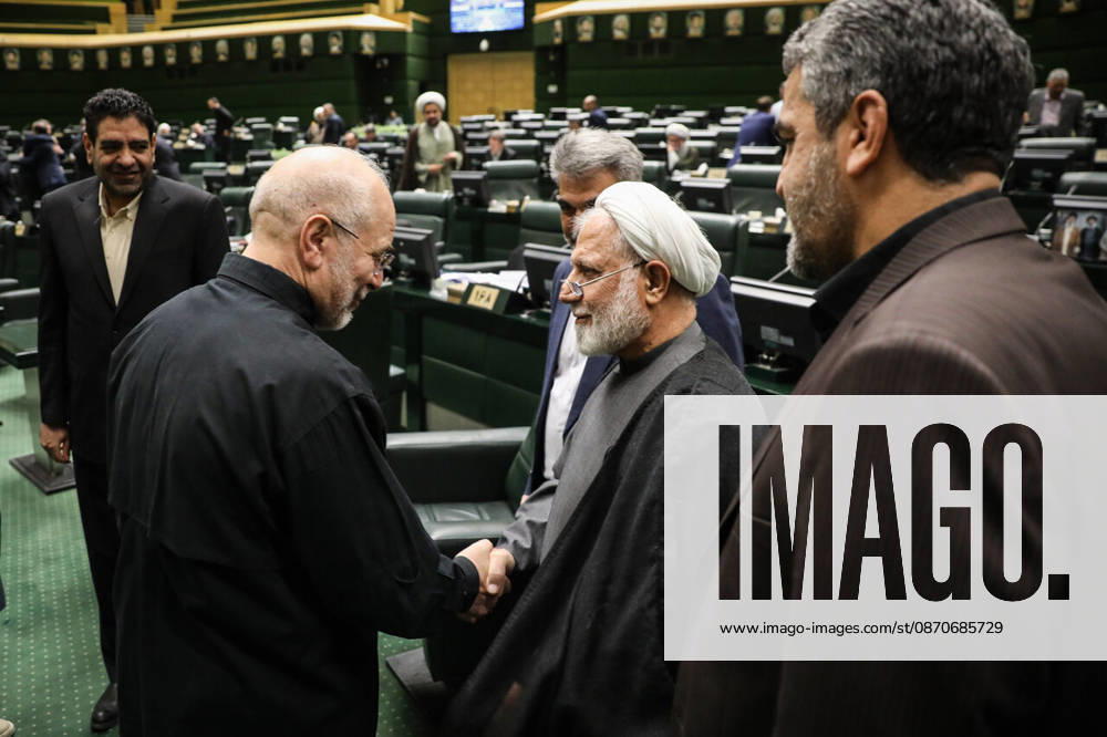 Mohammad Bagher Ghalibaf shakes hands with a gray-haired cleric as other men stand around them in the parliament chamber at the Islamic Consultative Assembly in Tehran, Iran, on October 25, 2026. Parliamentary reports said more than two-thirds of lawmakers joined the October 25 open sitting of the Islamic Consultative Assembly, attending either in person or remotely. Tehran Iran - ZUMAi98_ 20261025_zih_i98_035