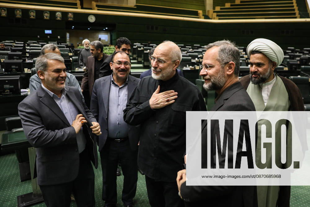Mohammad Bagher Ghalibaf puts a hand on his chest as he talks with suited men and a cleric standing in a group at the Islamic Consultative Assembly in Tehran, Iran, on October 25, 2026. The Islamic Consultative Assembly resumed an open sitting in its Tehran chamber with a mix of in-person and remote participation, according to parliamentary reporting. Tehran Iran - ZUMAi98_ 20261025_zih_i98_058
