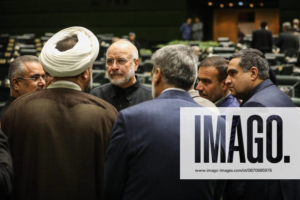 Mohammad Bagher Ghalibaf stands in a circle of suited men and a white-turbaned cleric on the chamber floor at the Islamic Consultative Assembly in Tehran, Iran, on October 25, 2026. Parliamentary reports said more than two-thirds of lawmakers joined the October 25 open sitting of the Islamic Consultative Assembly, attending either in person or remotely. Tehran Iran - ZUMAi98_ 20261025_zih_i98_061