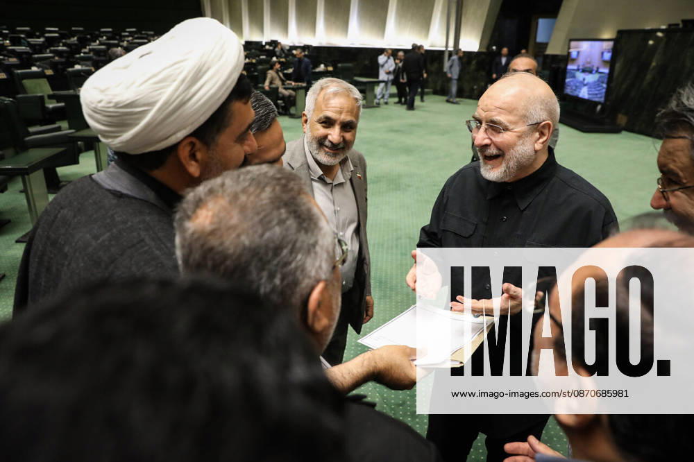 Mohammad Bagher Ghalibaf gestures toward a paper being held by another man while several lawmakers listen at the Islamic Consultative Assembly in Tehran, Iran, on October 25, 2026. Parliamentary reports said more than two-thirds of lawmakers joined the October 25 open sitting of the Islamic Consultative Assembly, attending either in person or remotely. Tehran Iran - ZUMAi98_ 20261025_zih_i98_062