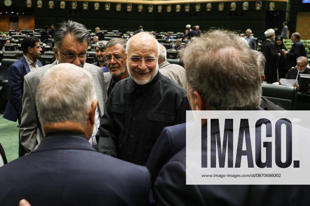 Mohammad Bagher Ghalibaf smiles while talking with two men whose backs are to the camera at the Islamic Consultative Assembly in Tehran, Iran, on October 25, 2026. The Islamic Consultative Assembly resumed an open sitting in its Tehran chamber with a mix of in-person and remote participation, according to parliamentary reporting. Tehran Iran - ZUMAi98_ 20261025_zih_i98_057