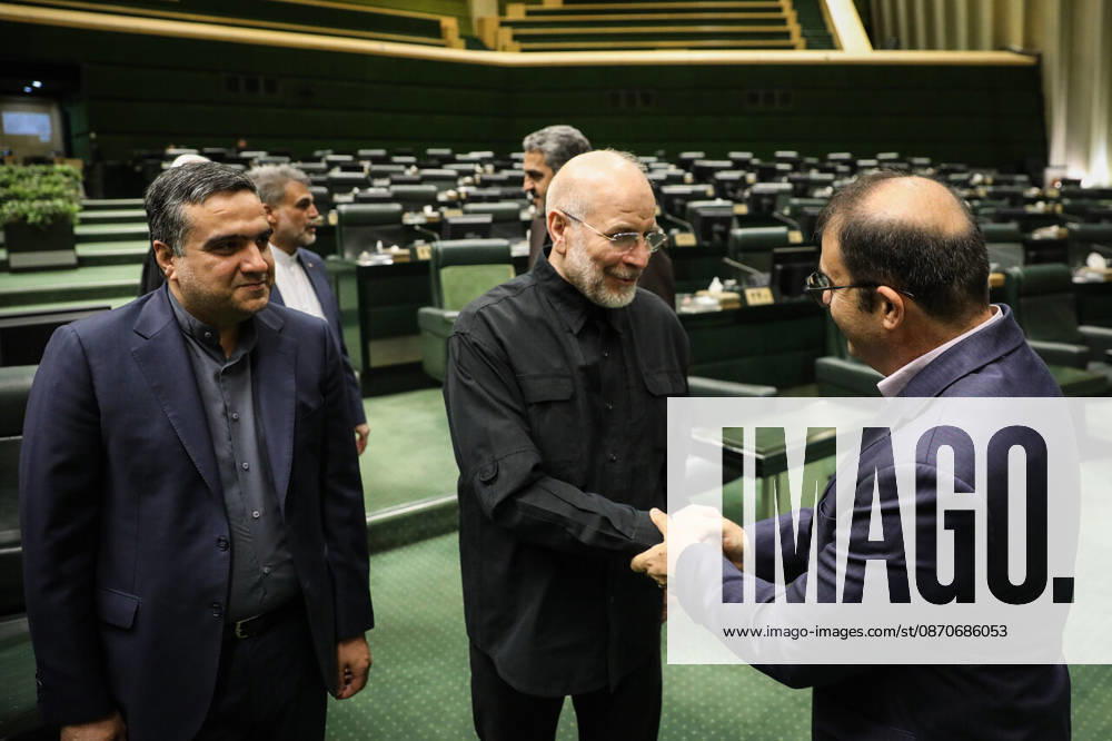 Mohammad Bagher Ghalibaf shakes hands with a suited lawmaker standing beside the chamber s green benches at the Islamic Consultative Assembly in Tehran, Iran, on October 25, 2026. Speaker Mohammad Bagher Ghalibaf chaired the October 25 session, which combined physical attendance at the Islamic Consultative Assembly with participation by video link. Tehran Iran - ZUMAi98_ 20261025_zih_i98_069