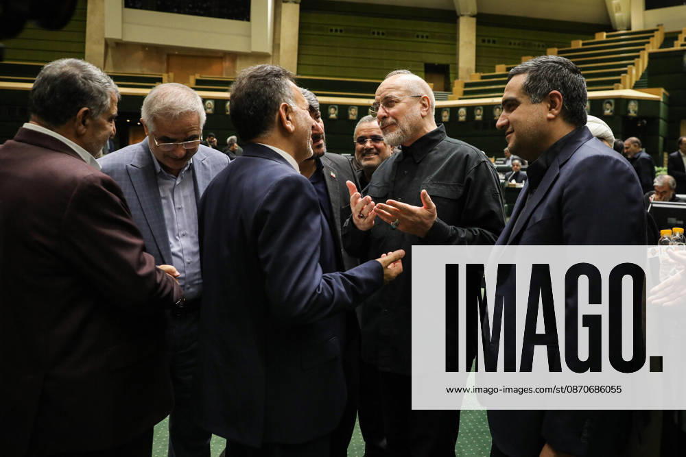 Mohammad Bagher Ghalibaf speaks with several members of parliament, raising one hand with fingers spread at the Islamic Consultative Assembly in Tehran, Iran, on October 25, 2026. Speaker Mohammad Bagher Ghalibaf chaired the October 25 session, which combined physical attendance at the Islamic Consultative Assembly with participation by video link. Tehran Iran - ZUMAi98_ 20261025_zih_i98_070