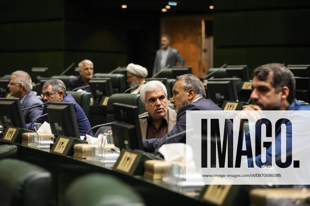 Lawmakers sit and speak across several rows of computer-equipped desks, with a man in a blue jacket in the foreground at the Islamic Consultative Assembly in Tehran, Iran, on October 25, 2026. Speaker Mohammad Bagher Ghalibaf chaired the October 25 session, which combined physical attendance at the Islamic Consultative Assembly with participation by video link. Tehran Iran - ZUMAi98_ 20261025_zih_i98_084