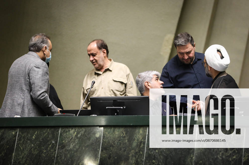 Several parliamentary officials gather around the raised front desk, one speaking to a seated colleague at the Islamic Consultative Assembly in Tehran, Iran, on October 25, 2026. Parliamentary reports said more than two-thirds of lawmakers joined the October 25 open sitting of the Islamic Consultative Assembly, attending either in person or remotely. Tehran Iran - ZUMAi98_ 20261025_zih_i98_094