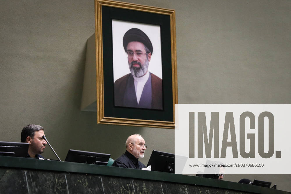 Mohammad Bagher Ghalibaf sits at the speaker s desk beneath a large framed portrait on the wall at the Islamic Consultative Assembly in Tehran, Iran, on October 25, 2026. The Iranian parliament held a hybrid open sitting, with some lawmakers attending in the Tehran chamber and others participating remotely, according to parliamentary reports. Tehran Iran - ZUMAi98_ 20261025_zih_i98_096
