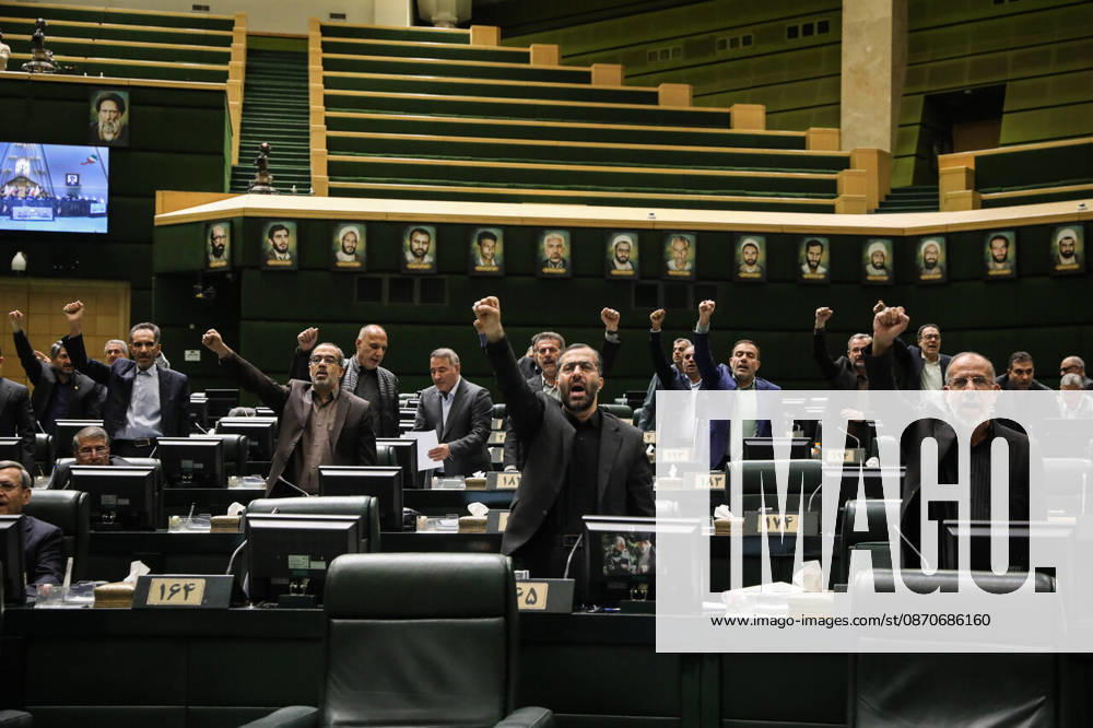 Members of parliament raise their fists or hands from the chamber floor during the open session at the Islamic Consultative Assembly in Tehran, Iran, on October 25, 2026. Speaker Mohammad Bagher Ghalibaf chaired the October 25 session, which combined physical attendance at the Islamic Consultative Assembly with participation by video link. Tehran Iran - ZUMAi98_ 20261025_zih_i98_100