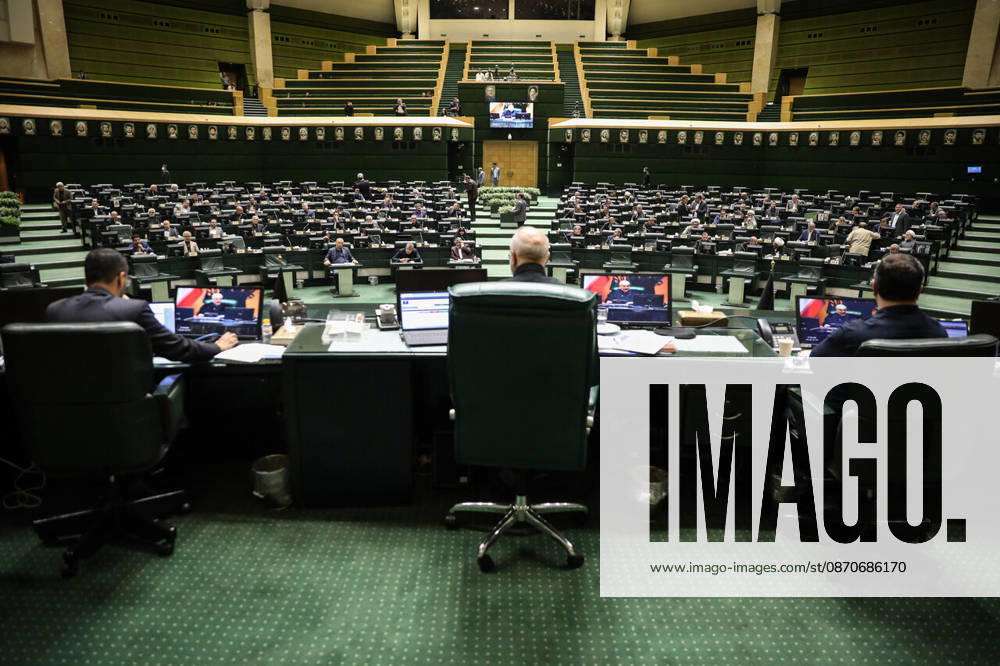 The chamber s curved rows of green seats extend toward the distant speaker s desk, seen from behind the presiding area at the Islamic Consultative Assembly in Tehran, Iran, on October 25, 2026. The Islamic Consultative Assembly resumed an open sitting in its Tehran chamber with a mix of in-person and remote participation, according to parliamentary reporting. Tehran Iran - ZUMAi98_ 20261025_zih_i98_104