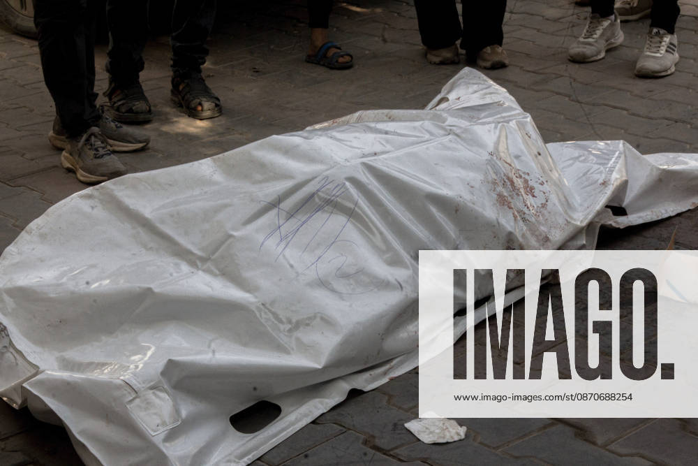 Gaza Israeli University Strike 2026 A white body bag lies on the pavement surrounded by mourners ahead of a funeral in Gaza City, Palestine, on October 25, 2026. According to information provided by local sources, three Islamic University guards, Ashraf Dahlan, Shadi Abu Ataya and Sami Baroud, were killed and others injured in an Israeli strike on the university campus in western Gaza City. Palestinian media reported that a second drone strike hit the campus after an earlier attack injured several people and prompted the university to suspend activities. Gaza Gaza Strip Palestinian Territories