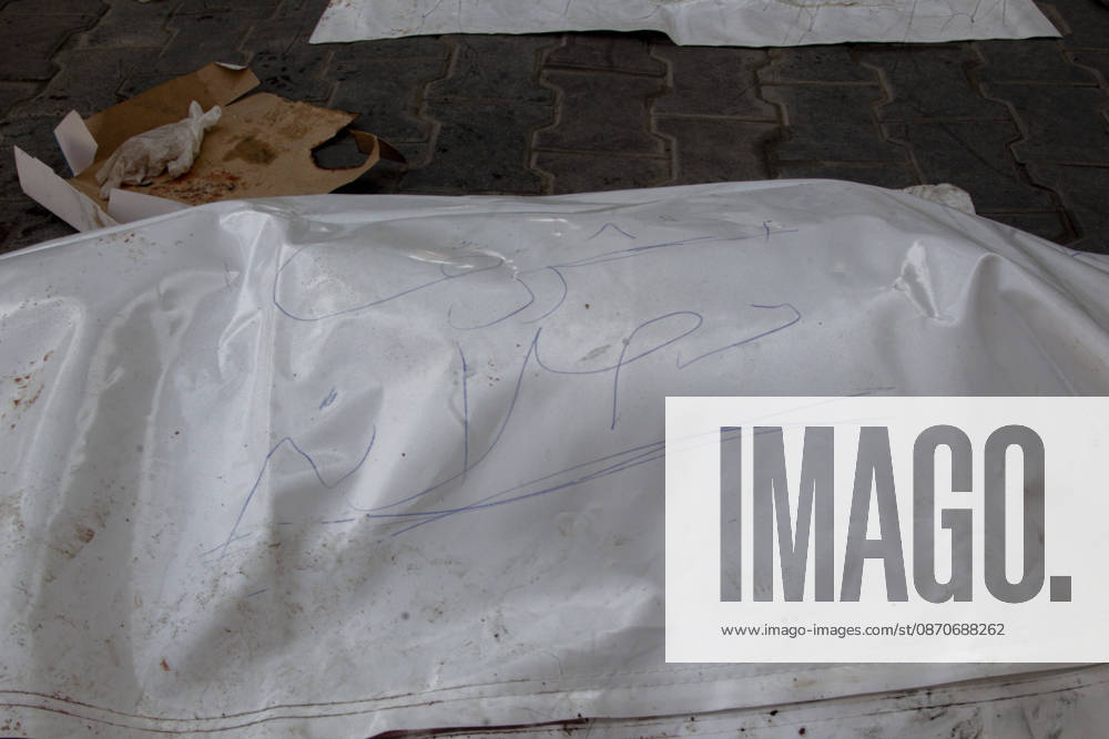 Gaza Israeli University Strike 2026 A white body bag with handwritten markings lies on the pavement before a funeral in Gaza City, Palestine, on October 25, 2026. According to information provided by local sources, three Islamic University guards, Ashraf Dahlan, Shadi Abu Ataya and Sami Baroud, were killed and others injured in an Israeli strike on the university campus in western Gaza City. Palestinian media reported that a second drone strike hit the campus after an earlier attack injured several people and prompted the university to suspend activities. Gaza Gaza Strip Palestinian Territories