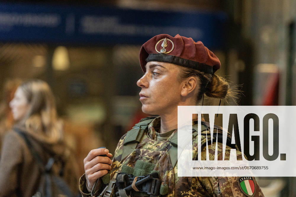 A female soldier from the Folgore Parachute Brigade, an elite unit of the Italian Army, patrols the Milan Cadorna railway station shortly before an unauthorized demonstration. The event takes place the weekend following protests against the high cost of living, which escalated into urban guerrilla warfare, resulting in the looting of shops and damage to entire streets. Milan Italy - ZUMAc276 20261025_zip_c276_008