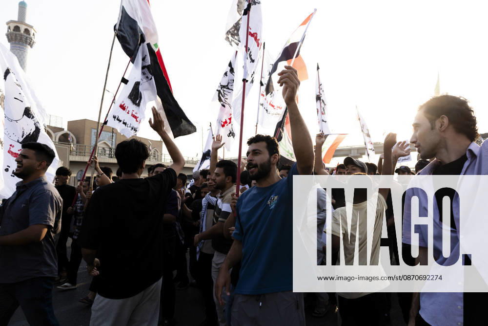 Najaf Iraq October Protest Demonstrators carry flags through a street during a protest in Najaf, Iraq on October 25, 2026. The protest marked the seventh anniversary of the October 2019 protest movement, with participants calling for political reform, anti-corruption measures, improved public services and more jobs. Najaf Najaf Iraq