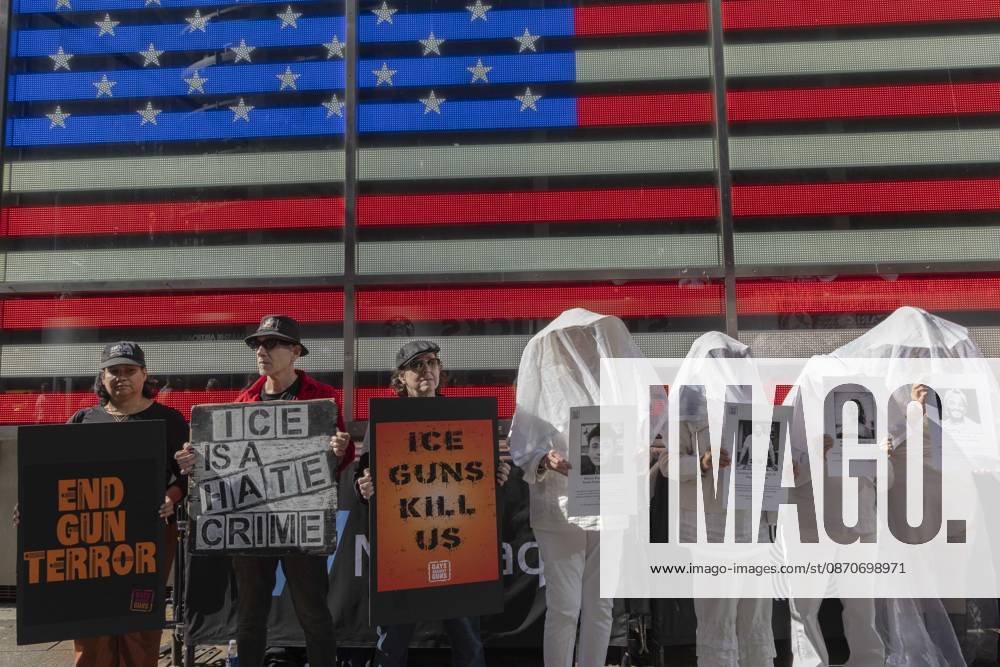 Demonstrators with the anti-gun violence organization Gays Against Guns protest under the Times Square US Army Recruiting Station LED American flag to denounce U.S. Immigration and Customs Enforcement (ICE) and President Trump s immigrant detention and mass deportation policies. Protesters hold signs that read END GUN TERROR ICE IS A HATE CRIME ICE GUNS KILL US. People dressed in white shrouds are Human Beings, memorializing people killed by gun violence from Federal immigration agents by holding signs with their images and names. New York USA - ZUMAr174 20261025_znp_r174_005