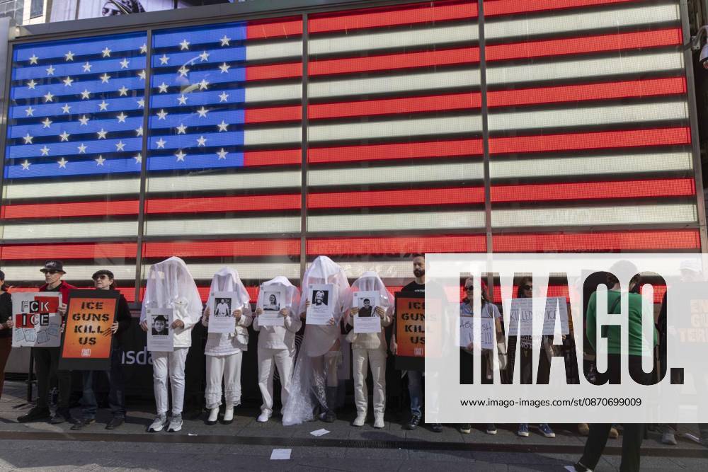 Demonstrators with the anti-gun violence organization Gays Against Guns protest under the Times Square US Army Recruiting Station LED American flag to denounce U.S. Immigration and Customs Enforcement (ICE) and President Trump s immigrant detention and mass deportation policies. Protesters hold signs that read ICE GUNS KILL US. People dressed in white shrouds are Human Beings, memorializing people killed by gun violence from Federal immigration agents by holding signs with their images and names. New York USA - ZUMAr174 20261025_znp_r174_013