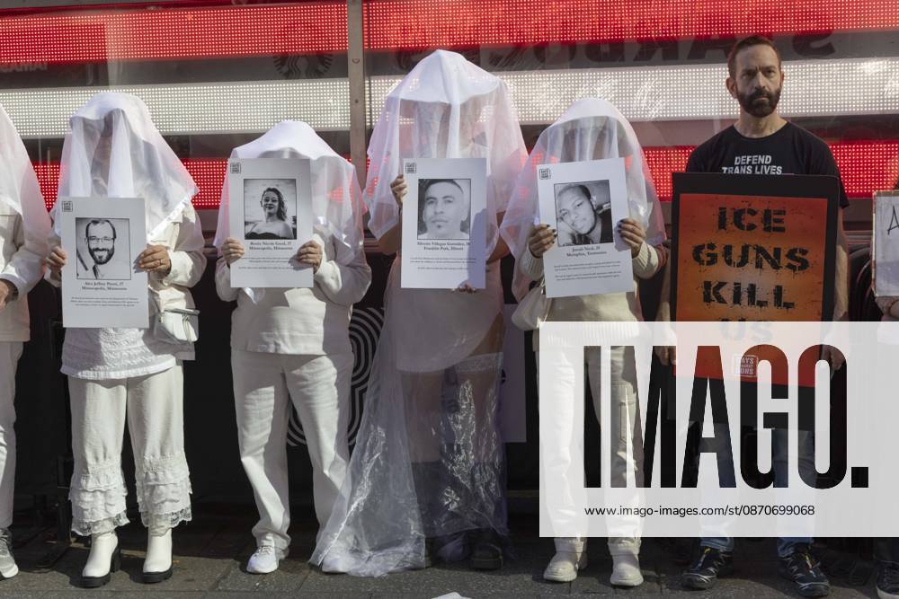 People dressed in white shrouds are Human Beings, memorializing people killed by gun violence from Federal immigration agents by holding signs with the images and names of Alex Jeffrey Pretti Renee Nicole Good Silverio Villegas Gonzalez Jonah Neal. Demonstrators with the anti-gun violence organization Gays Against Guns protest under the Times Square US Army Recruiting Station LED American flag to denounce U.S. Immigration and Customs Enforcement (ICE,) President Trump s immigrant detention and mass deportation policies. Protesters hold signs that read ICE GUNS KILL US. New York USA - ZUMAr174 20261025_znp_r174_016