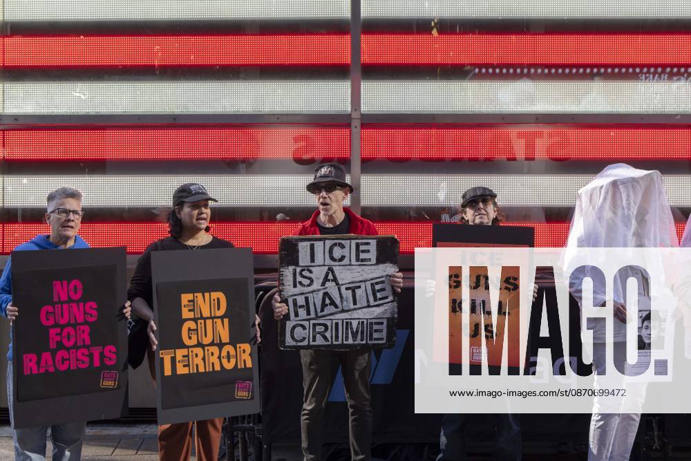 Demonstrators with the anti-gun violence organization Gays Against Guns protest under the Times Square US Army Recruiting Station LED American flag to denounce U.S. Immigration and Customs Enforcement (ICE) and President Trump s immigrant detention and mass deportation policies. People dressed in white shrouds are Human Beings, memorializing people killed by gun violence from Federal immigration agents by holding signs with their images and names. Protesters chant holding signs that read NO GUNS FOR RACISTS END GUN TERROR ICE IS A HATE CRIME ICE GUNS KILL US. New York USA - ZUMAr174 20261025_znp_r174_020