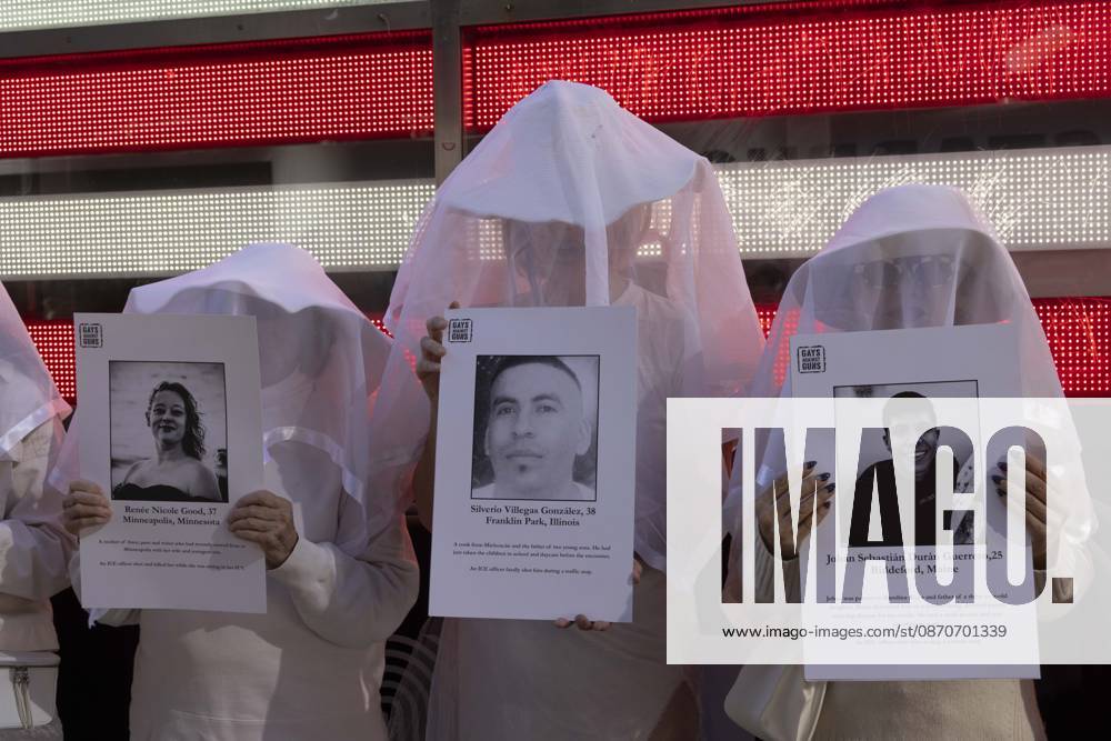 People dressed in white shrouds are Human Beings, memorializing people killed by gun violence from Federal immigration agents by holding signs with the images and names of Renee Nicole Good Silverio Villegas Gonzalez Johan Sebastian Duran Guerrero. Demonstrators with the anti-gun violence organization Gays Against Guns protest under the Times Square US Army Recruiting Station LED American flag to denounce U.S. Immigration and Customs Enforcement (ICE,) President Trump s immigrant detention and mass deportation policies. New York USA - ZUMAr174 20261025_znp_r174_009