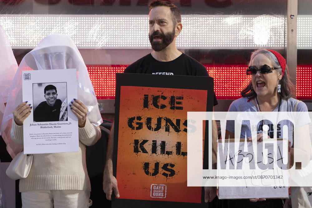 Demonstrators with the anti-gun violence organization Gays Against Guns protest under the Times Square US Army Recruiting Station LED American flag to denounce U.S. Immigration and Customs Enforcement (ICE) and President Trump s immigrant detention and mass deportation policies. Protesters chant holding signs that read ICE GUNS KILL US ABOLISH ICE!!! People dressed in white shrouds are Human Beings, memorializing people killed by gun violence from Federal immigration agents by holding signs with their images and names. New York USA - ZUMAr174 20261025_znp_r174_010
