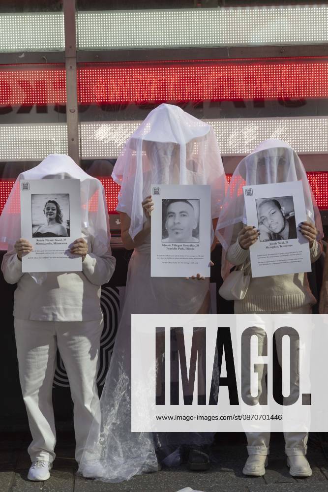 People dressed in white shrouds are Human Beings, memorializing people killed by gun violence from Federal immigration agents by holding signs with the images and names of Renee Nicole Good Silverio Villegas Gonzalez Jonah Neal. Demonstrators with the anti-gun violence organization Gays Against Guns protest under the Times Square US Army Recruiting Station LED American flag to denounce U.S. Immigration and Customs Enforcement (ICE,) President Trump s immigrant detention and mass deportation policies. New York USA - ZUMAr174 20261025_znp_r174_018