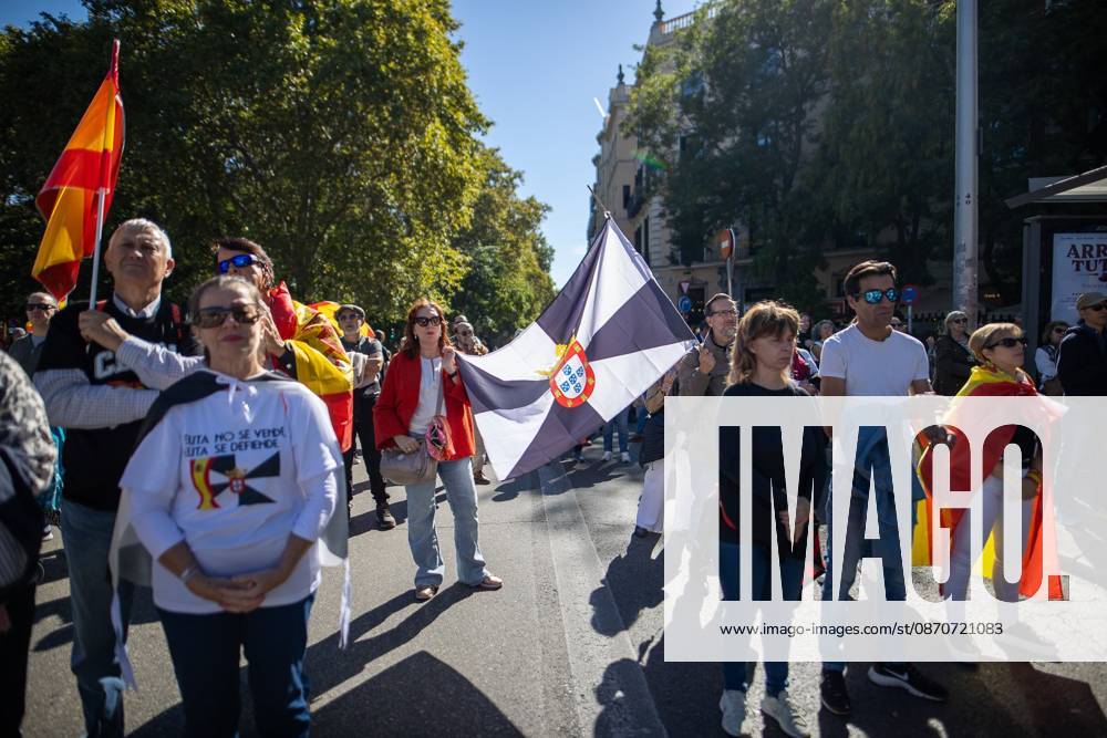 A march demanding solutions and a restoration of social normalcy in Ceuta - Madrid, Spain - 25 Oct 2026 A woman waves a flag of Ceuta. Thousands of people in Madrid have rallied in support of the demands made by women from Ceuta—known locally as caballas —who are calling for a return to normalcy in the autonomous city. Madrid Spain