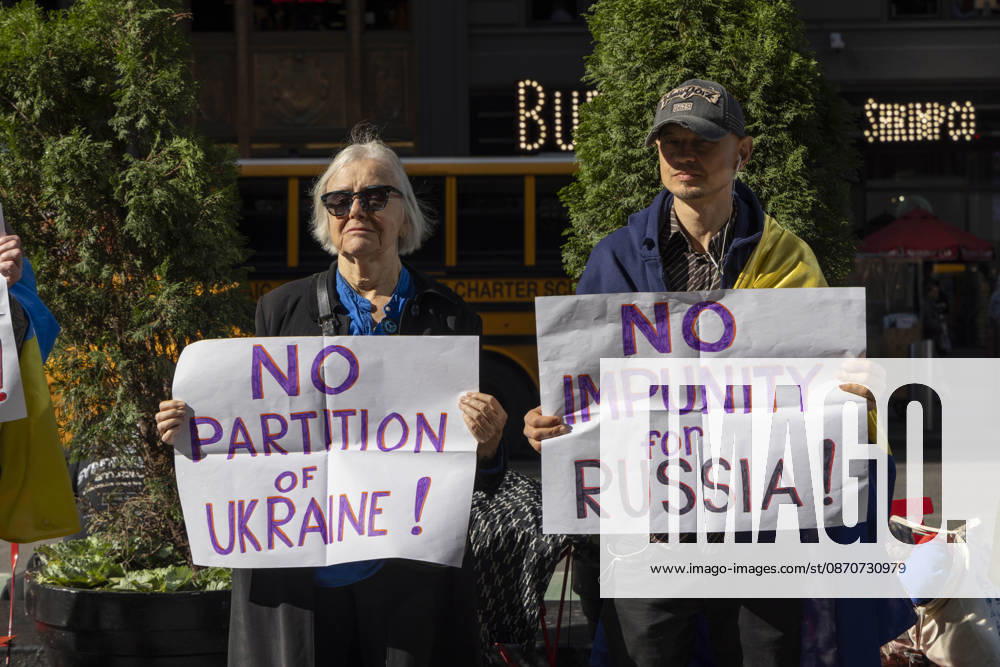 Demonstrators stand in Times Square holding signs that read NO PARTITION OF UKRAINE! NO IMPUNITY for RUSSIA. New York USA - ZUMAr174 20261025_znp_r174_021