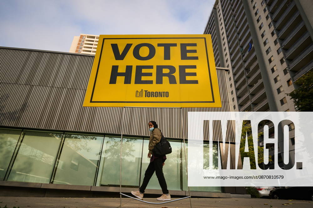 People pass election signage as they head to the polls to vote in Toronto s municipal election, on Monday, Oct. 26, 2026. Toronto Canada - ZUMAc35_ 20261026_zaf_c35_043