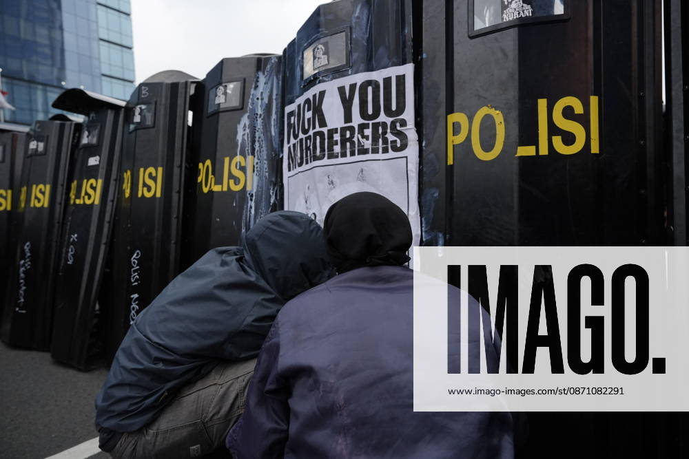 Student protesters crouch in front of police riot shields bearing a poster reading Fuck You Murderers during a demonstration at Bundaran HI Jakarta Indonesia - ZUMAm265 20261028_zip_m265_018