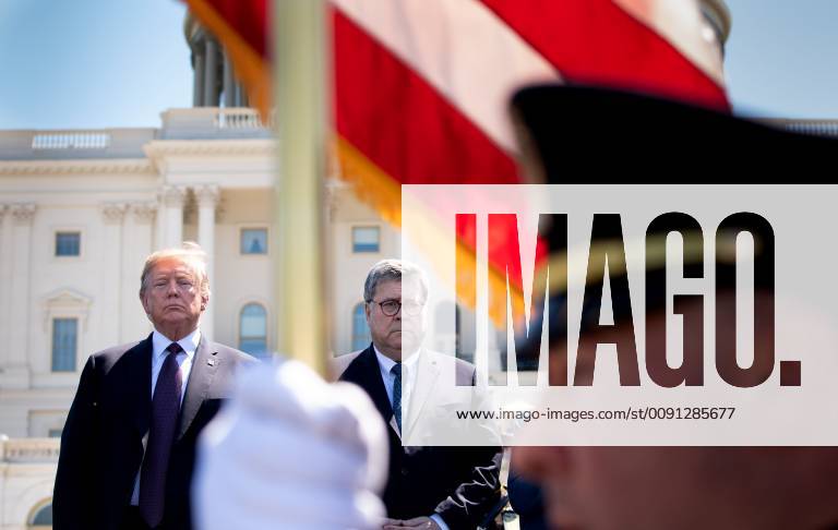 President Donald Trump (L) and Attorney General William Barr stand for the presentation of colors during the 38th annual National Peace Officers Memorial Service, at the U.S. Capitol in Washington, D.C. on May 15, 2019. WAP20190515306 KEVINxDIETSCH