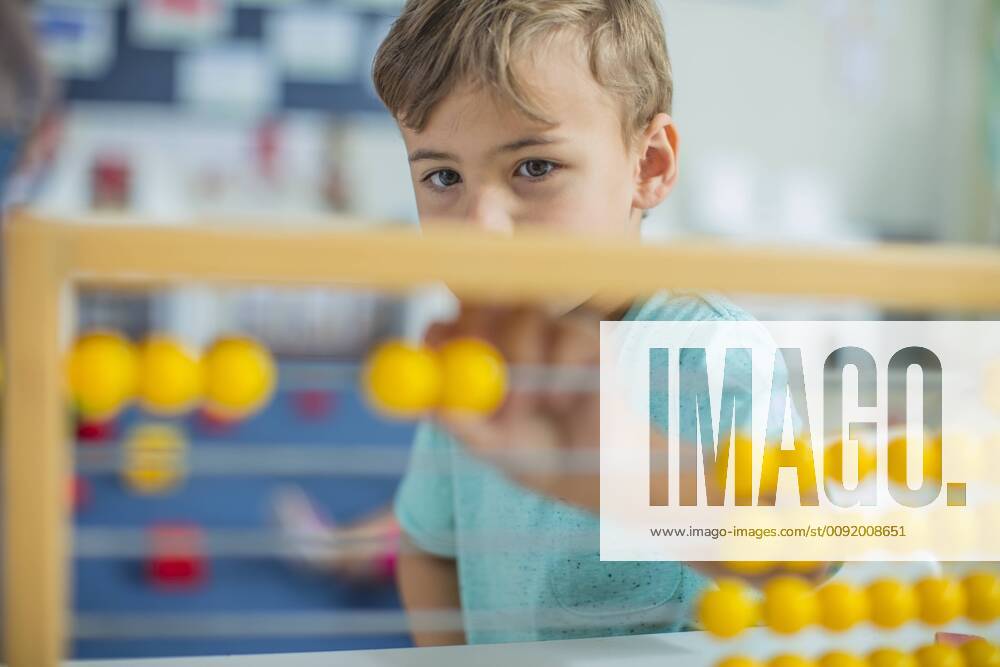 Boy in kindergarten using abacus model released Symbolfoto property released ZEF15446