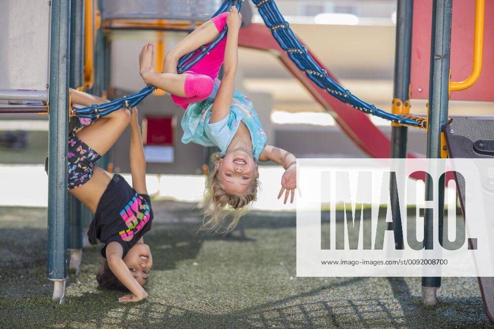 Happy girls playing on playground of a kindergarten model released Symbolfoto property released ZEF15479