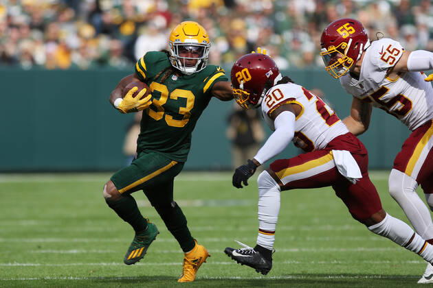 GREEN BAY, WI - OCTOBER 24: Green Bay Packers running back Aaron Jones (33) stiff arms Washington Football Team free safety Bobby McCain (20) during a game between the Green Bay Packers and the Washington Football Team at Lambeau Field on October 24, 2021 in Green Bay, WI. (Photo by Larry Radloff Icon Sportswire) NFL, American Football Herren, USA OCT 24 Washington Football Team at Packers Icon2110240708