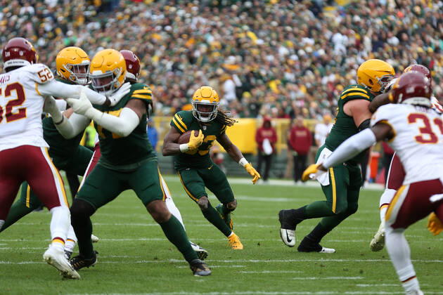GREEN BAY, WI - OCTOBER 24: Green Bay Packers running back Aaron Jones (33) runs through a hole during a game between the Green Bay Packers and the Washington Football Team at Lambeau Field on October 24, 2021 in Green Bay, WI. (Photo by Larry Radloff Icon Sportswire) NFL, American Football Herren, USA OCT 24 Washington Football Team at Packers Icon2110245043